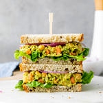head on view of stacked chickpea avocado salad sandwich.