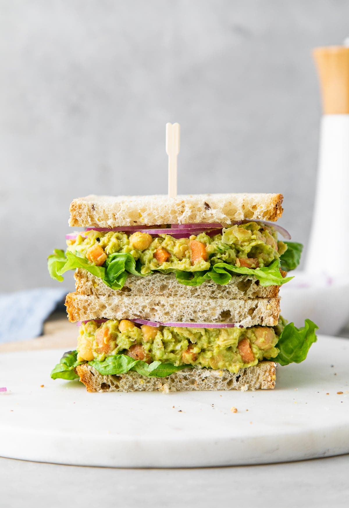 head on view of stacked chickpea avocado salad sandwich.