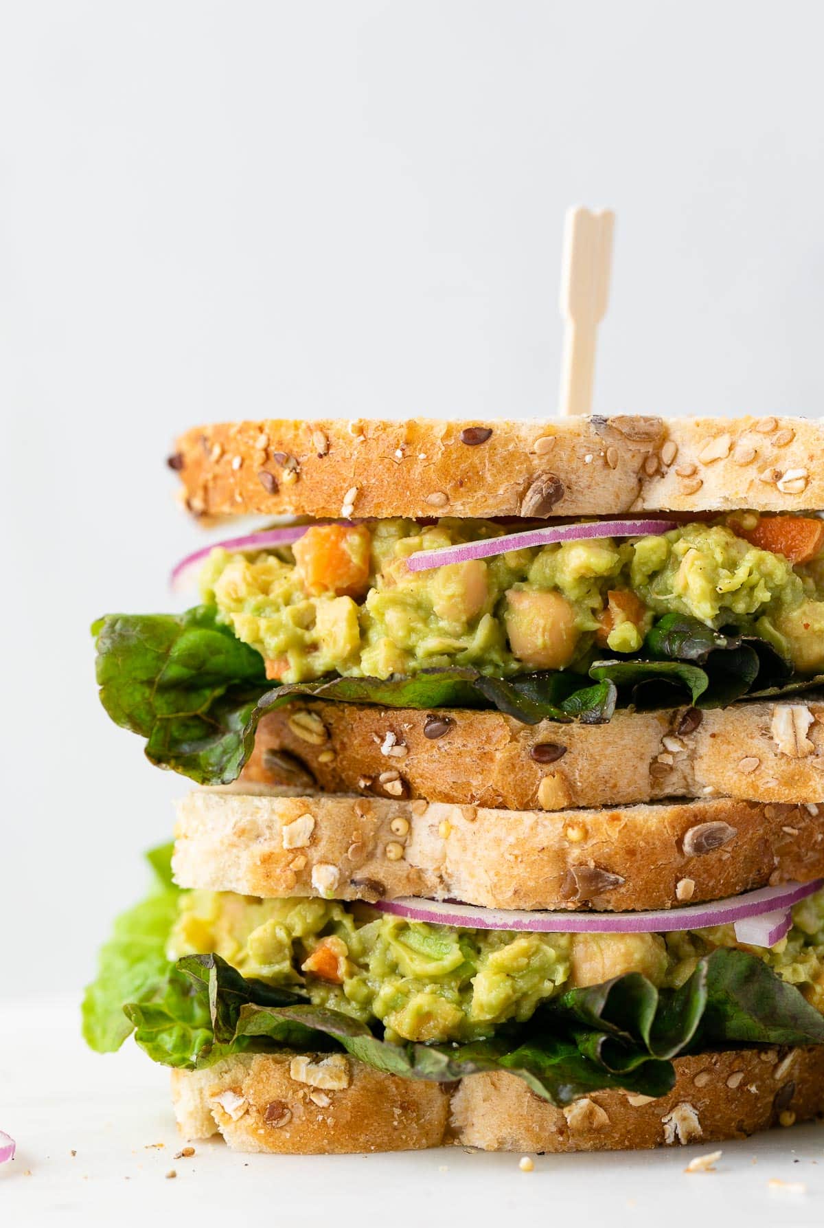 head on view of stacked chickpea avocado salad sandwich.