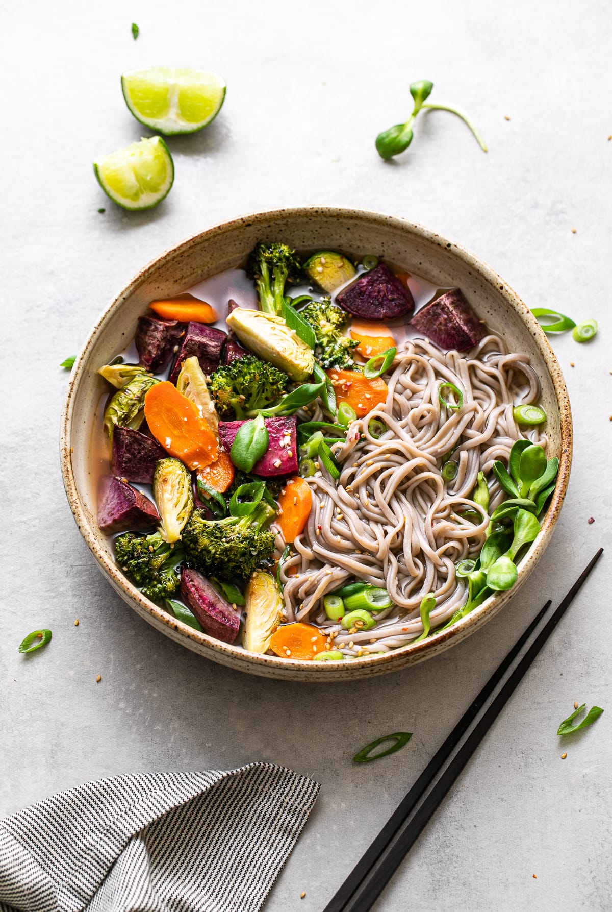 top down view of bowl with serving of soba miso soup with vegetables and items surrounding.