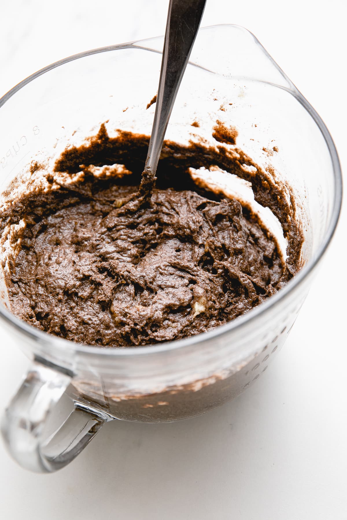 side angle view of glass bowl with buckwheat banana bread batter.