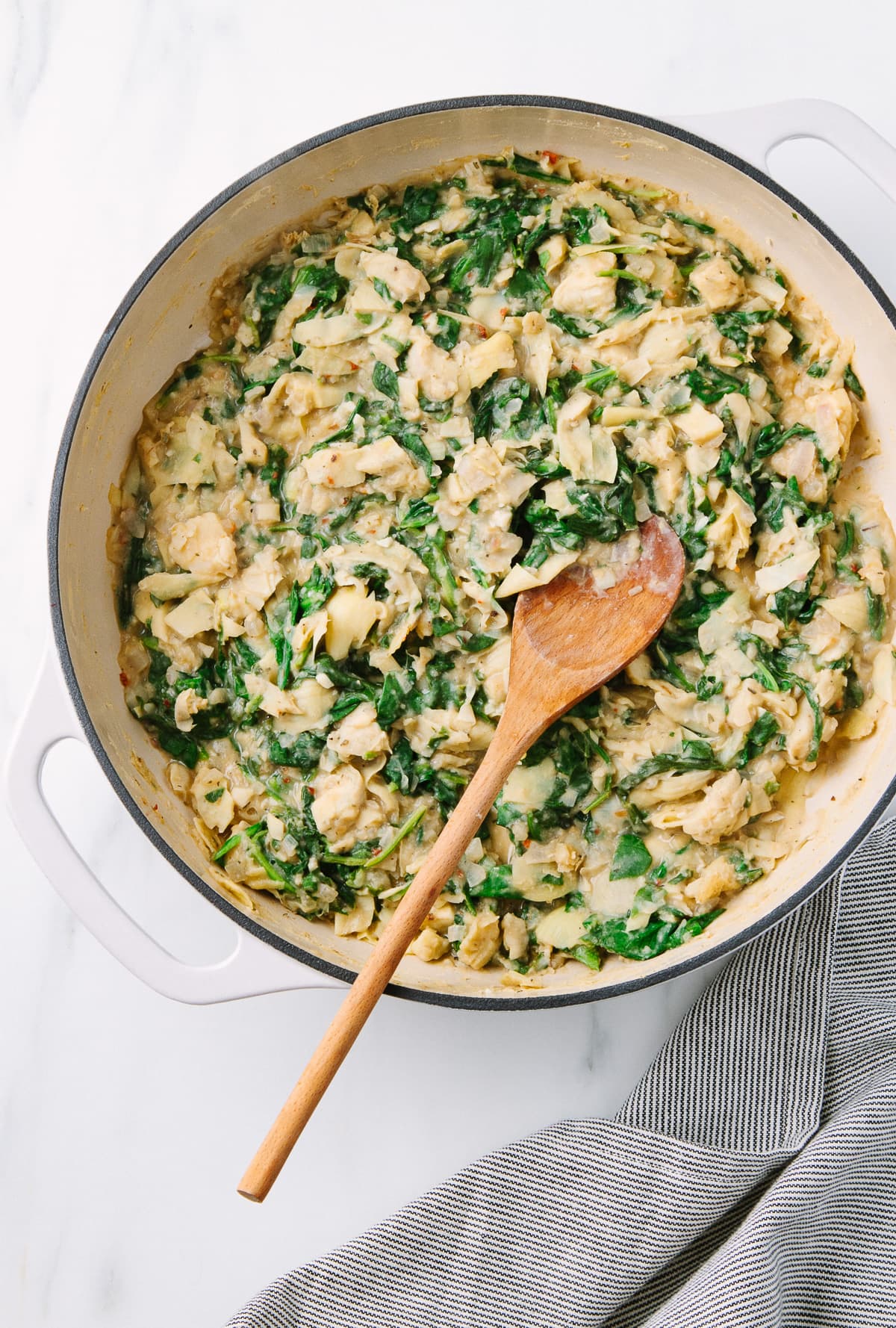 top down view of spinach artichoke dip freshly made in a pan.