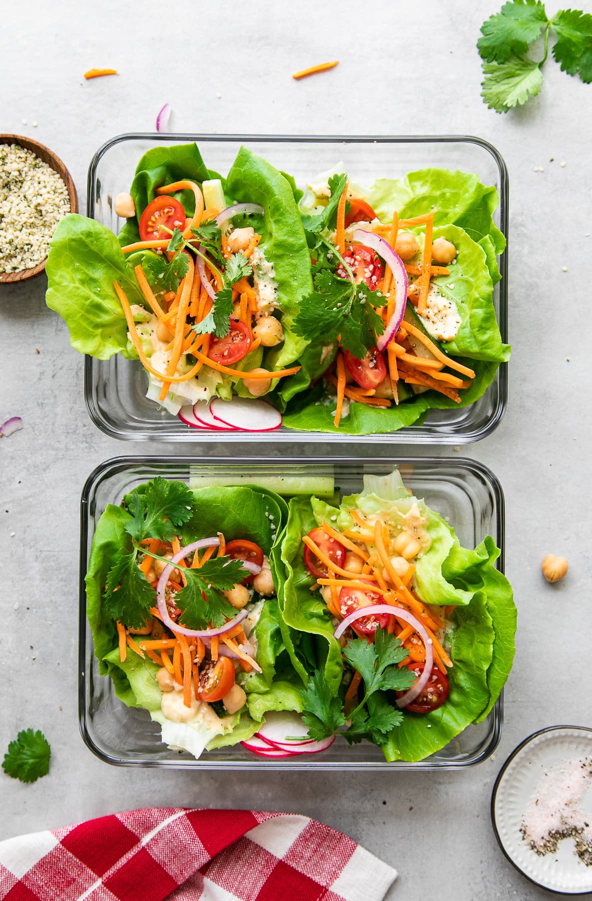 top down view of fresh veggie lettuce wraps meal prepped in glass containers.