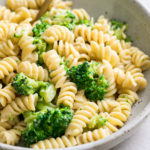 side angle view of creamy broccoli pasta in a bowl.