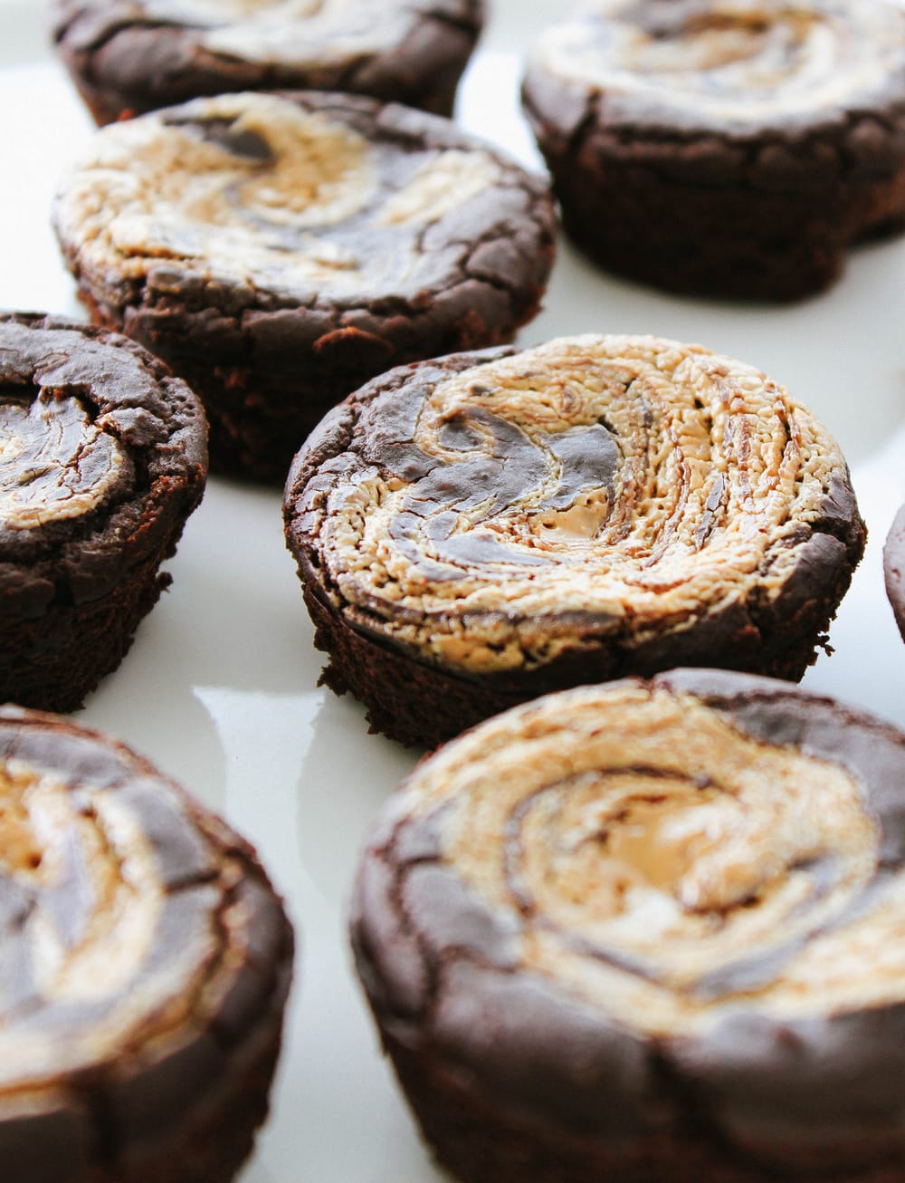 side angle view of cluster of homemade black bean brownies with nut butter swirl.