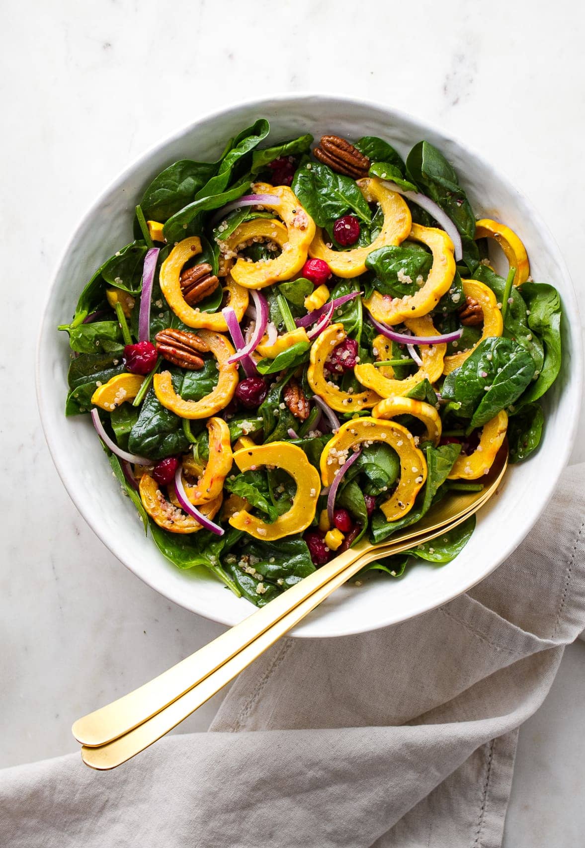 top down view of a large serving bowl filled with roasted delicata squash salad.
