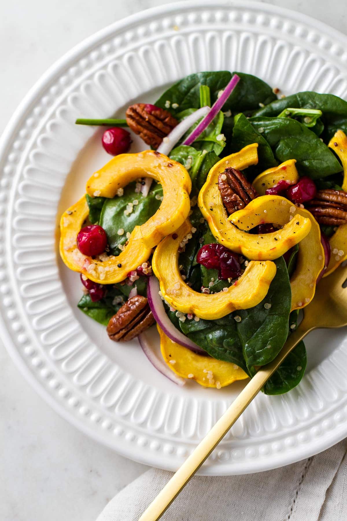 top down view of small plate with a serving of healthy roasted delicata squash salad.