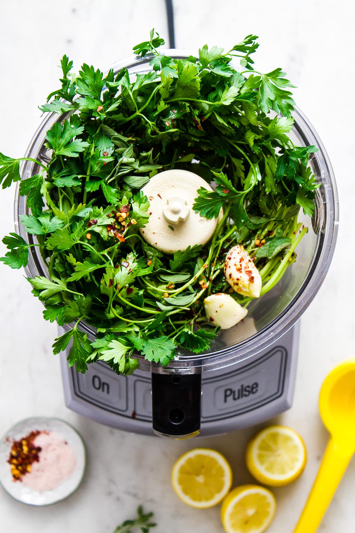 top down view of showing the process of making chimichurri in a food processor.