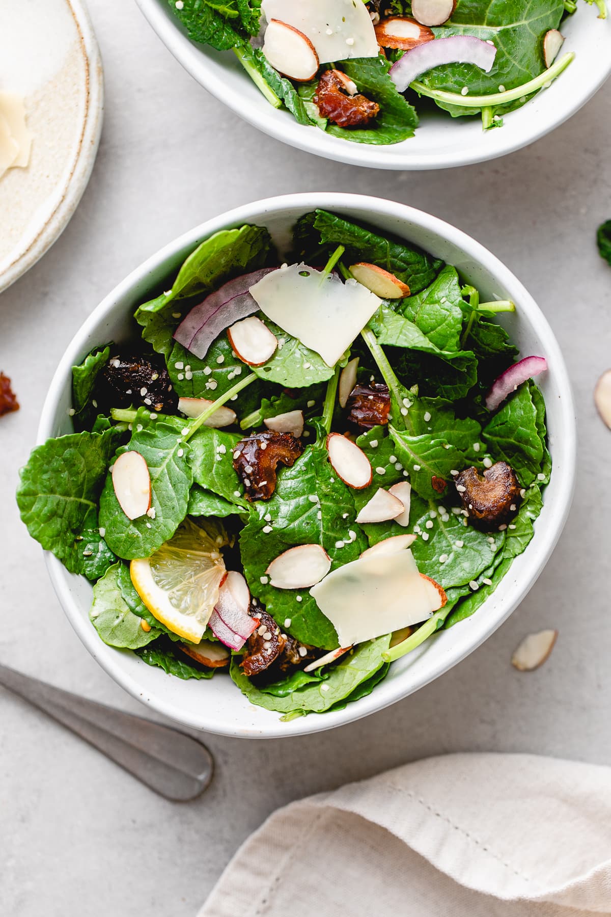 top down view of healthy kale salad with dates and almonds.