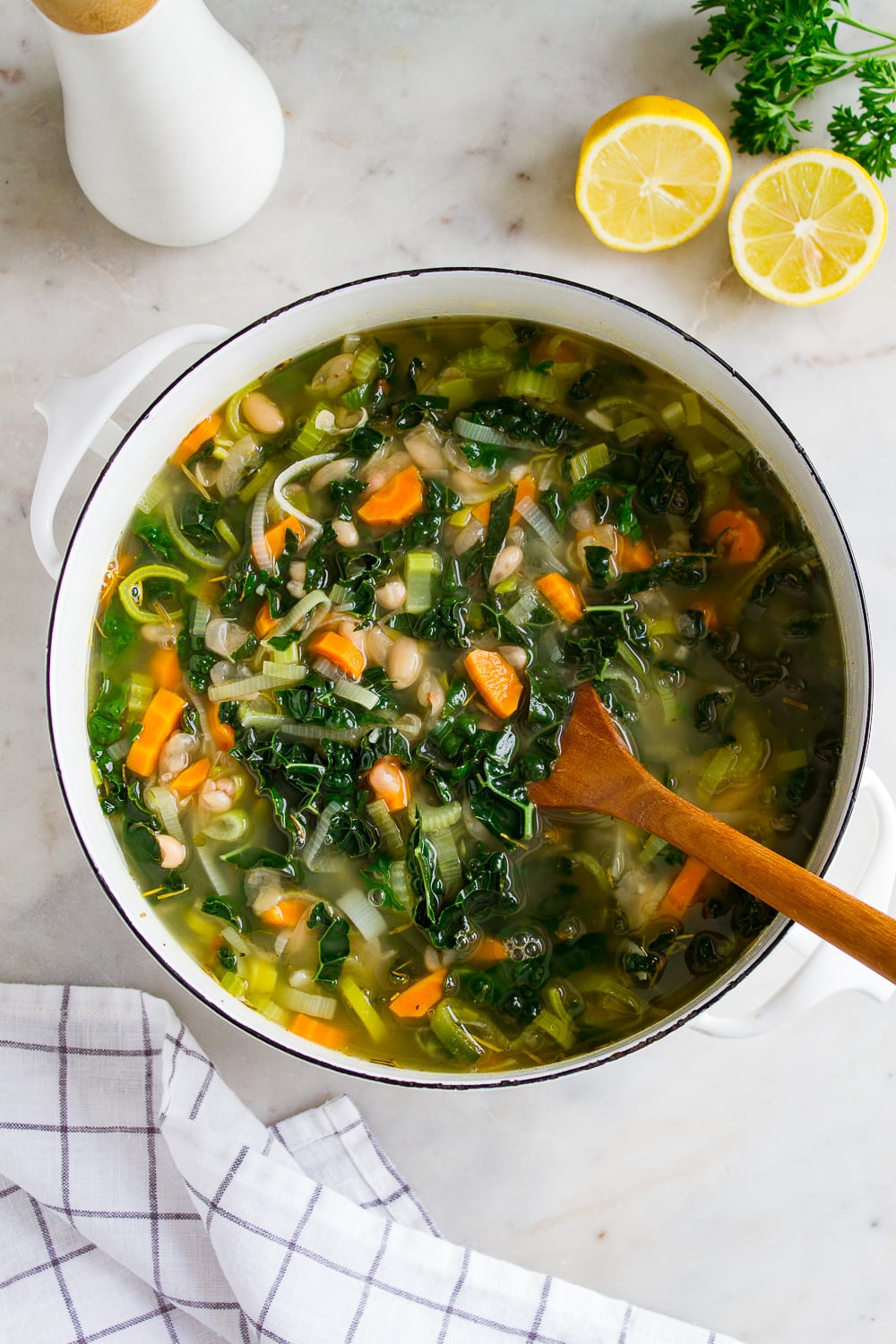 top down view of a freshly made pot of healthy kale and white bean soup with leeks.