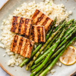 top down view of plated easy grilled tofu and asparagus with ginger cauliflower rice.