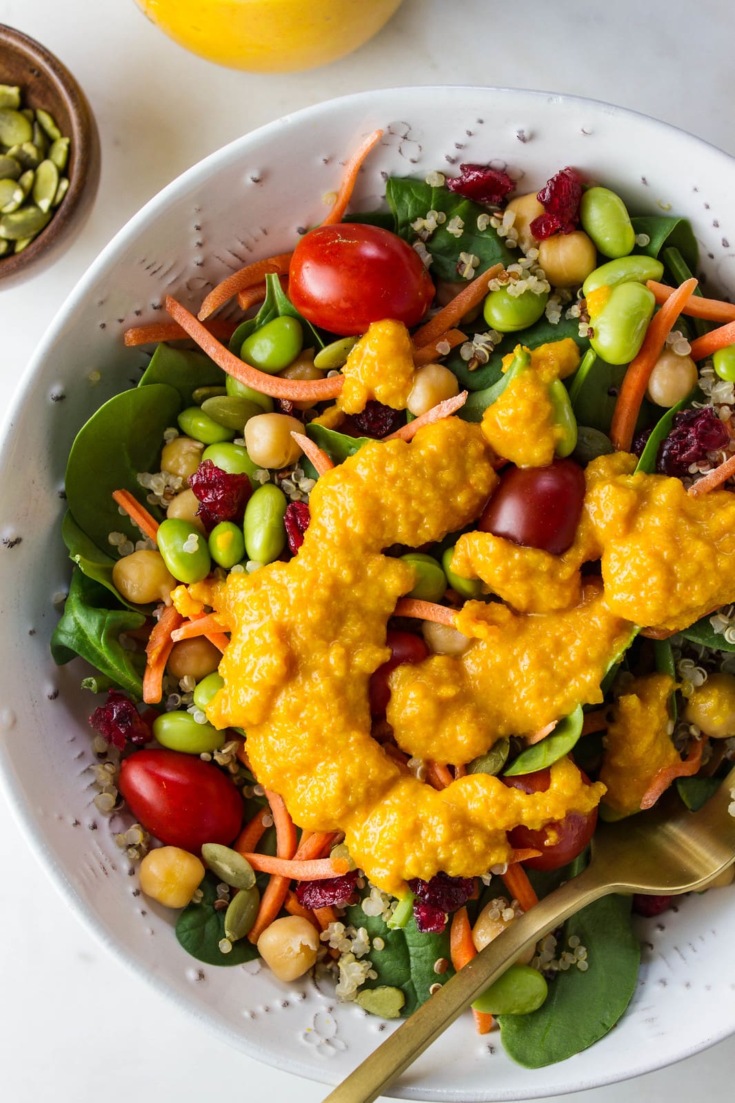 top down view of super spinach salad with carrot miso dressing.