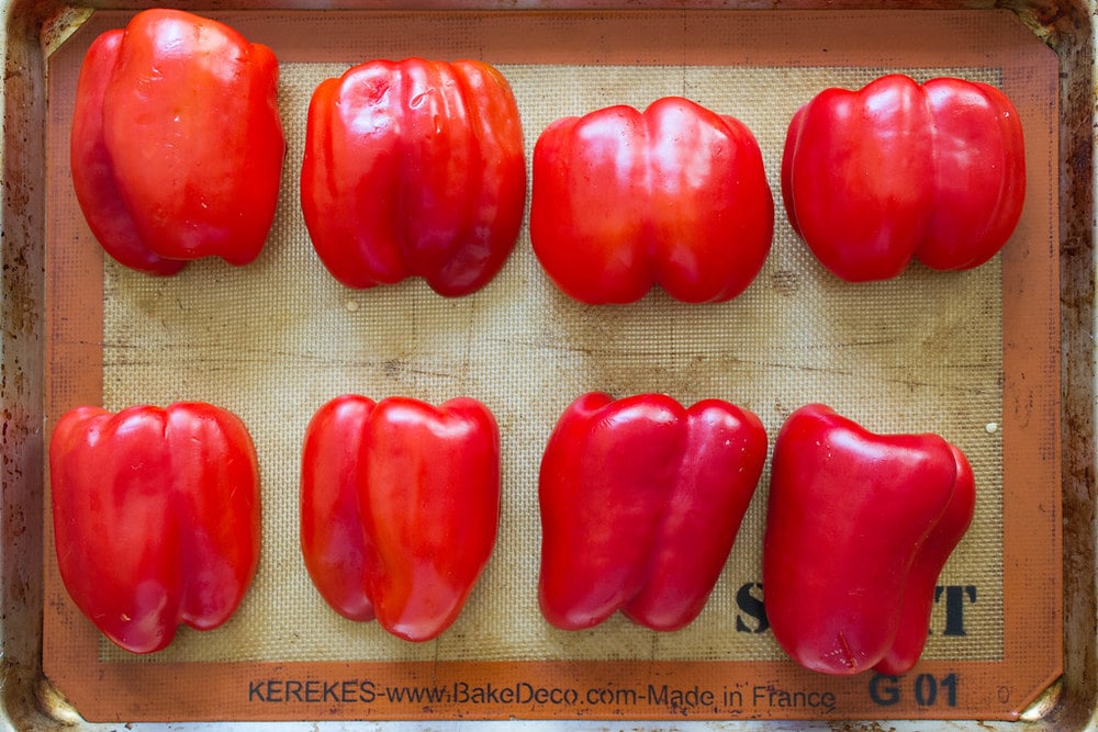 sliced red peppers prepped and ready for to be roasted in the oven.