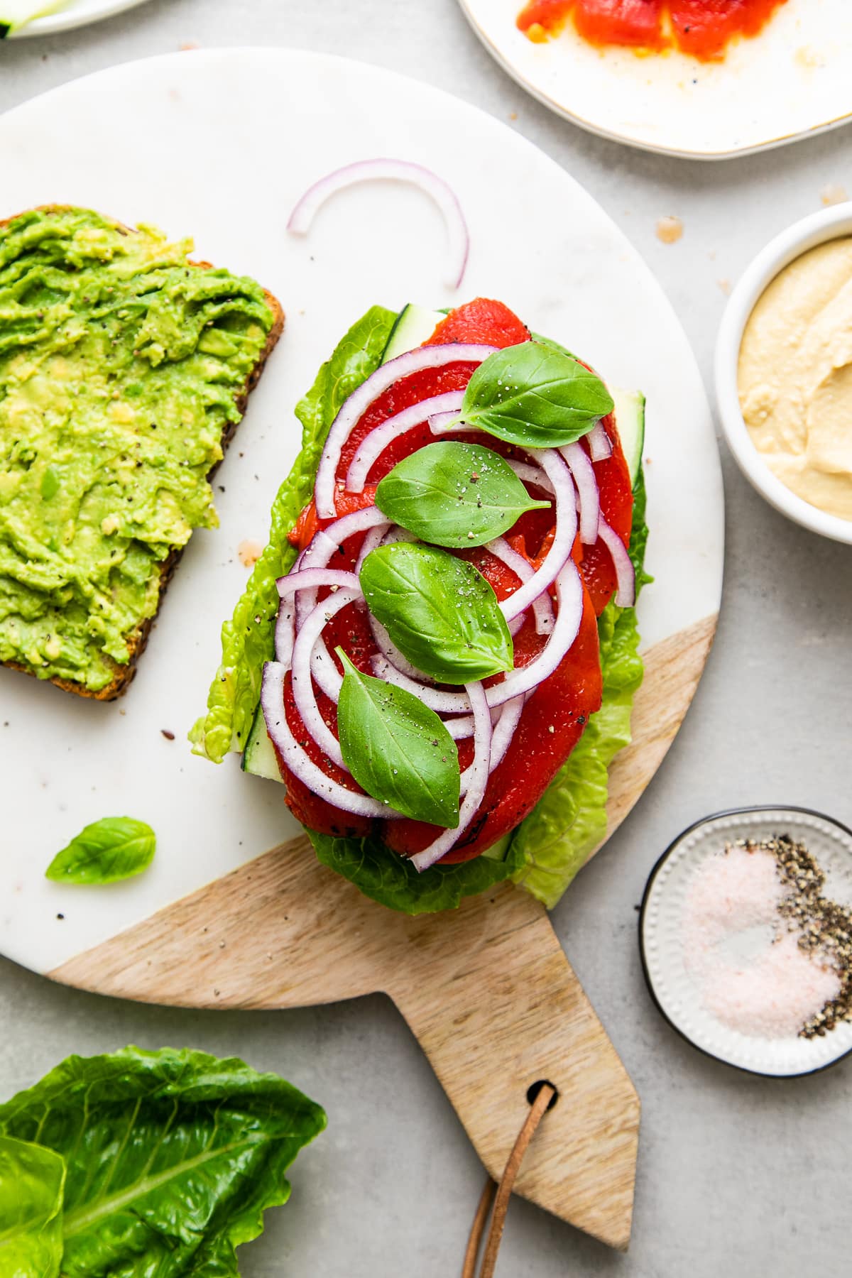 top down view of veggies layered on bread.