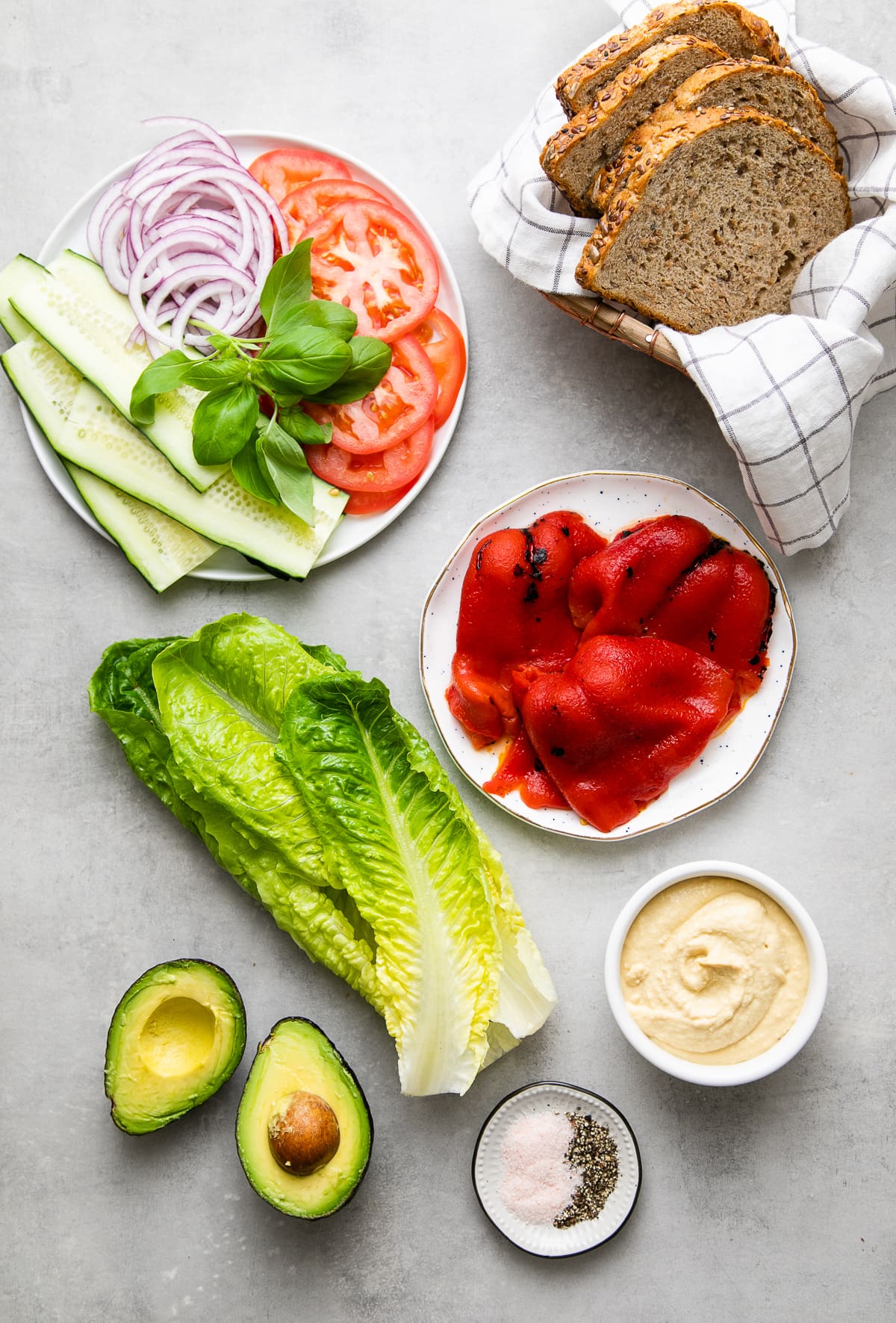 top down view of the ingredients needed to make the best mediterranean veggie sandwich.