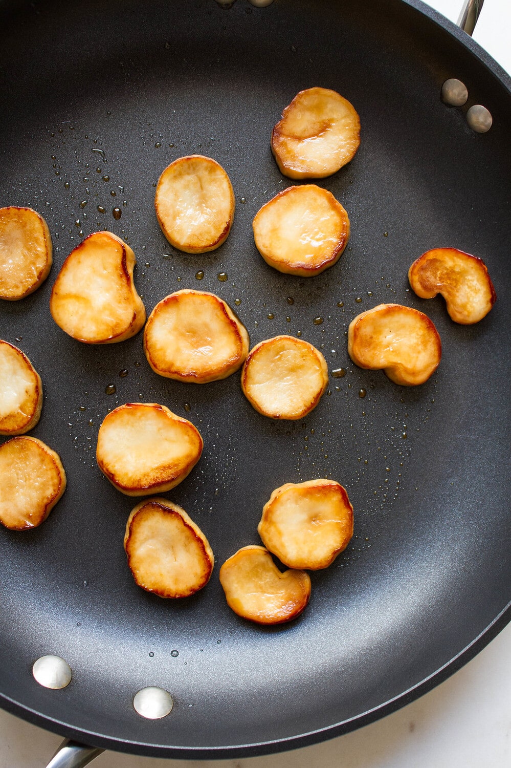 top down view of king oyster mushrooms freshly cooked in a skillet.