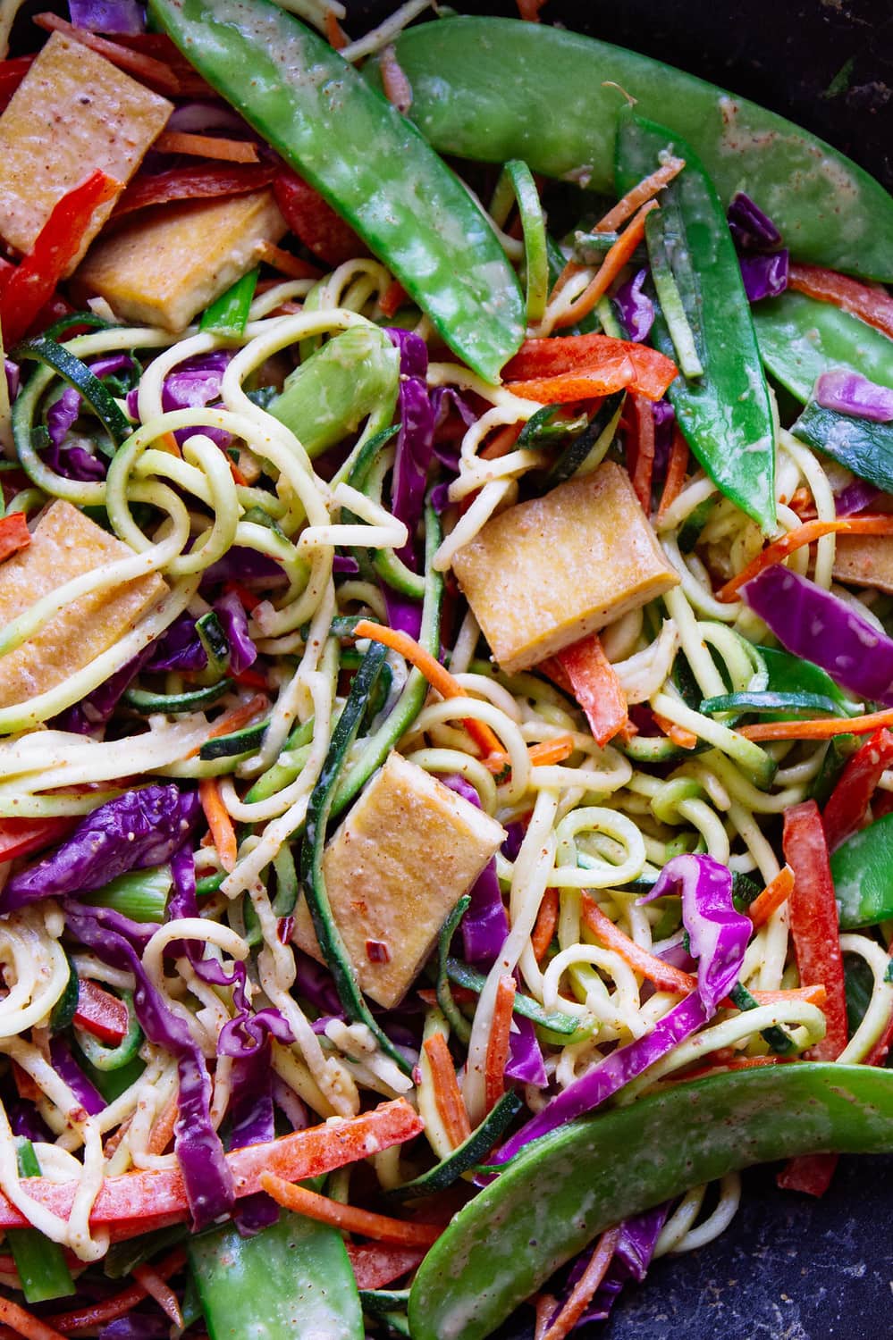 top down, up close, view of thai zucchini noodles with crispy tofu.