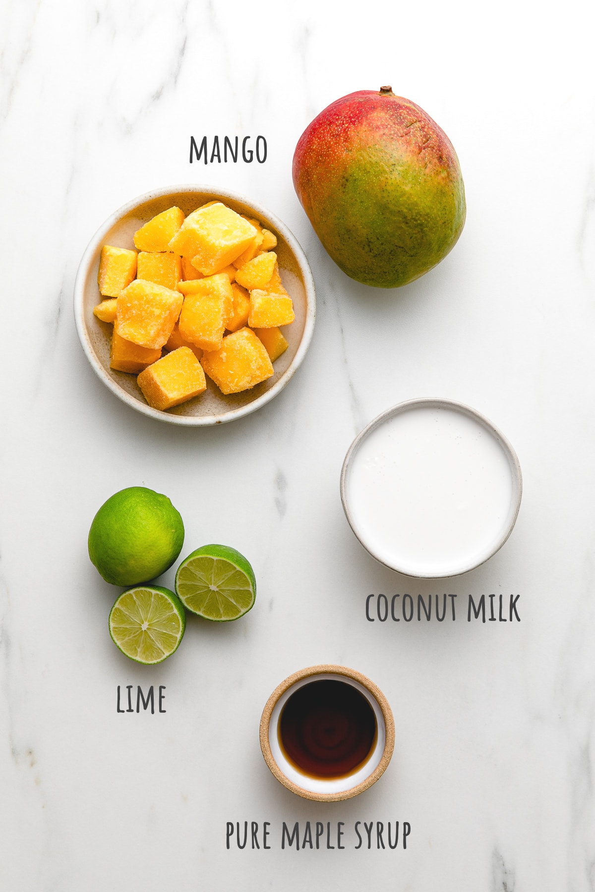 top down view of ingredients used to make mango coconut popsicles with granola.