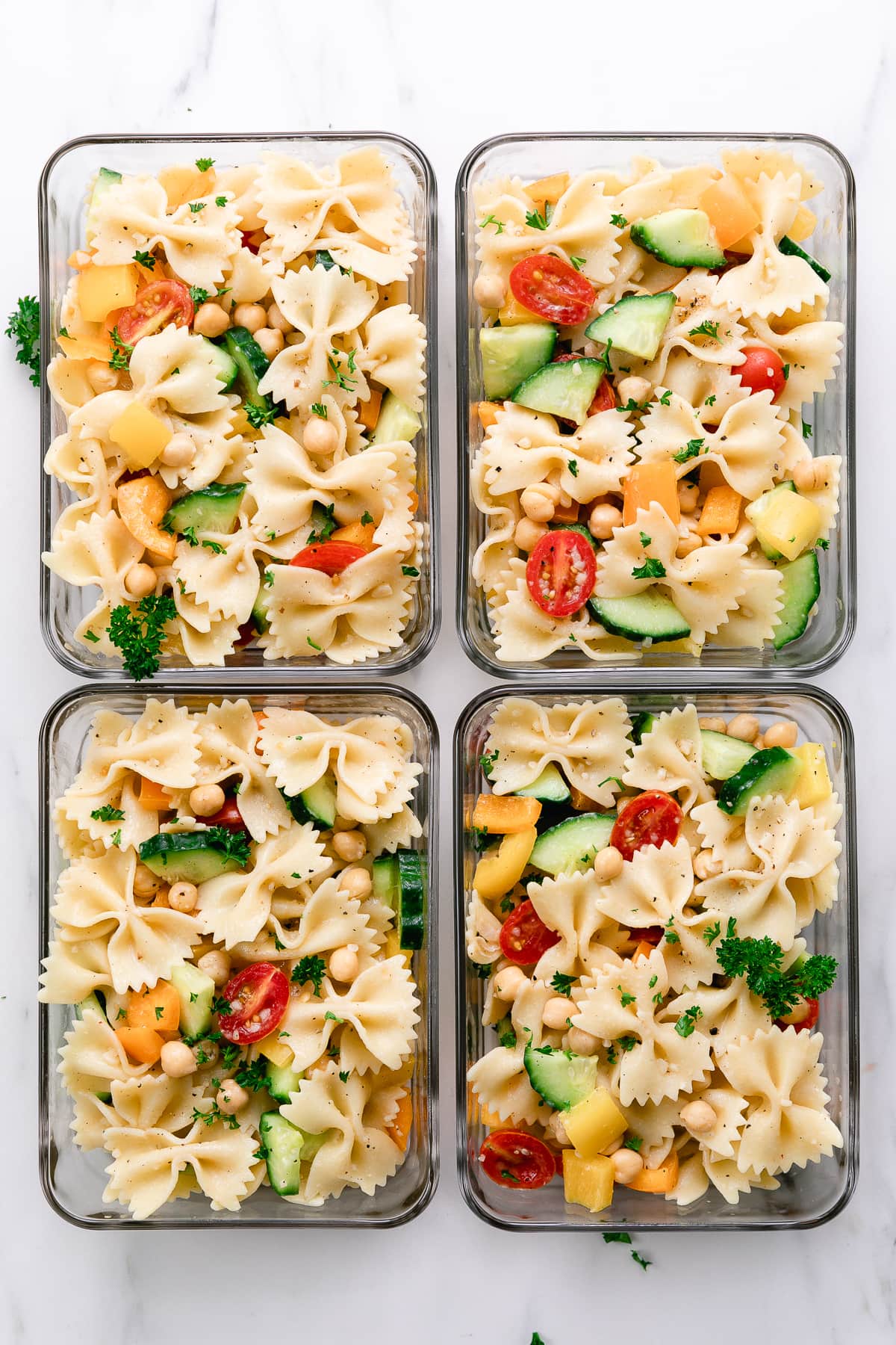 top down view of meal prepped vegetable pasta in glass containers.