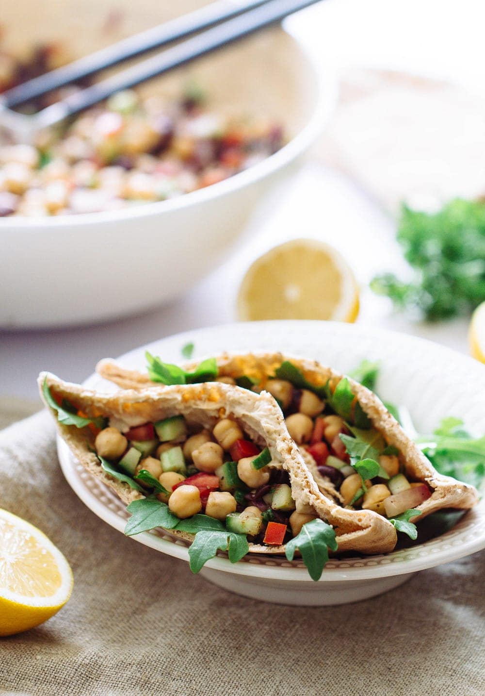 a side angle view of balela salad in pita bread making balela pita wraps