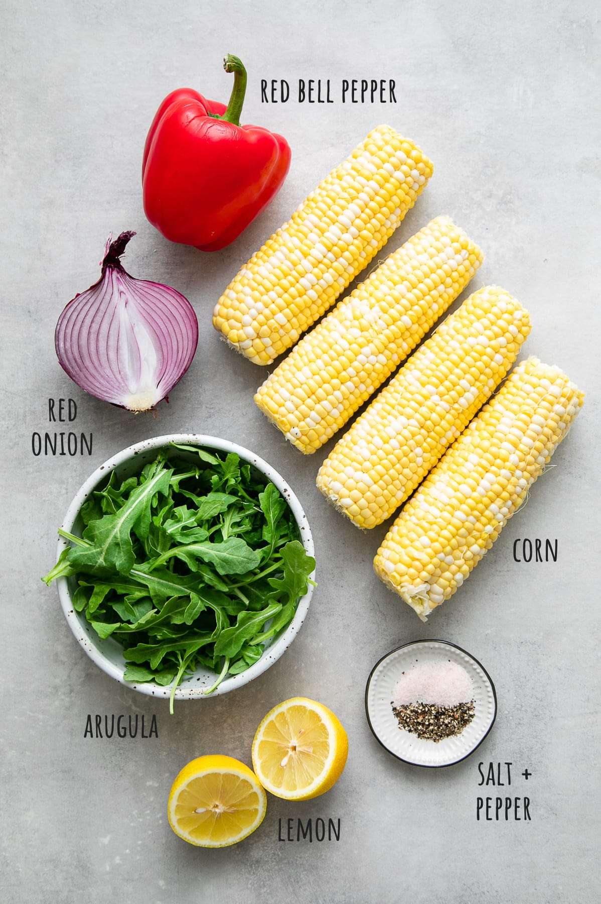 top down view of ingredients used to make corn arugula salad recipe.