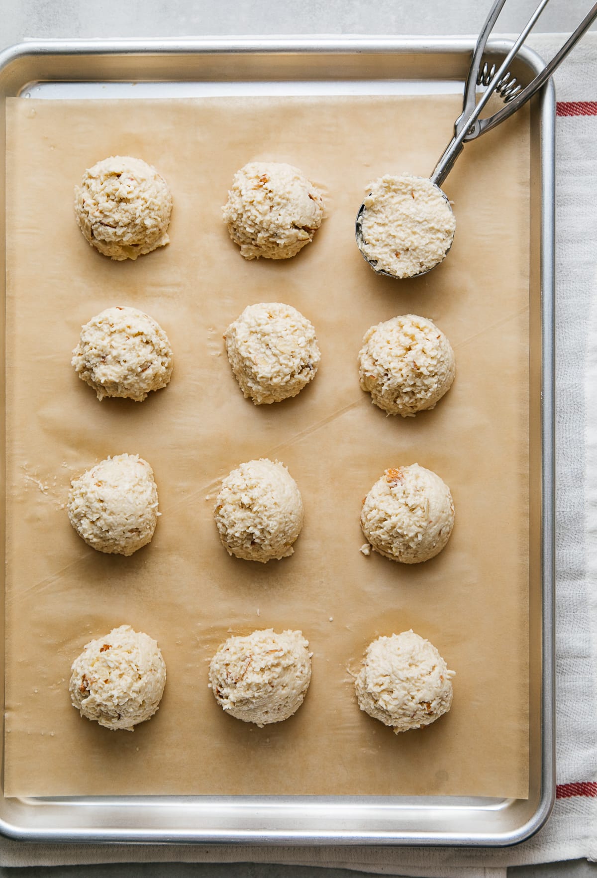 top down view of freshly formed coconut macaroons mounds on a baking sheet.