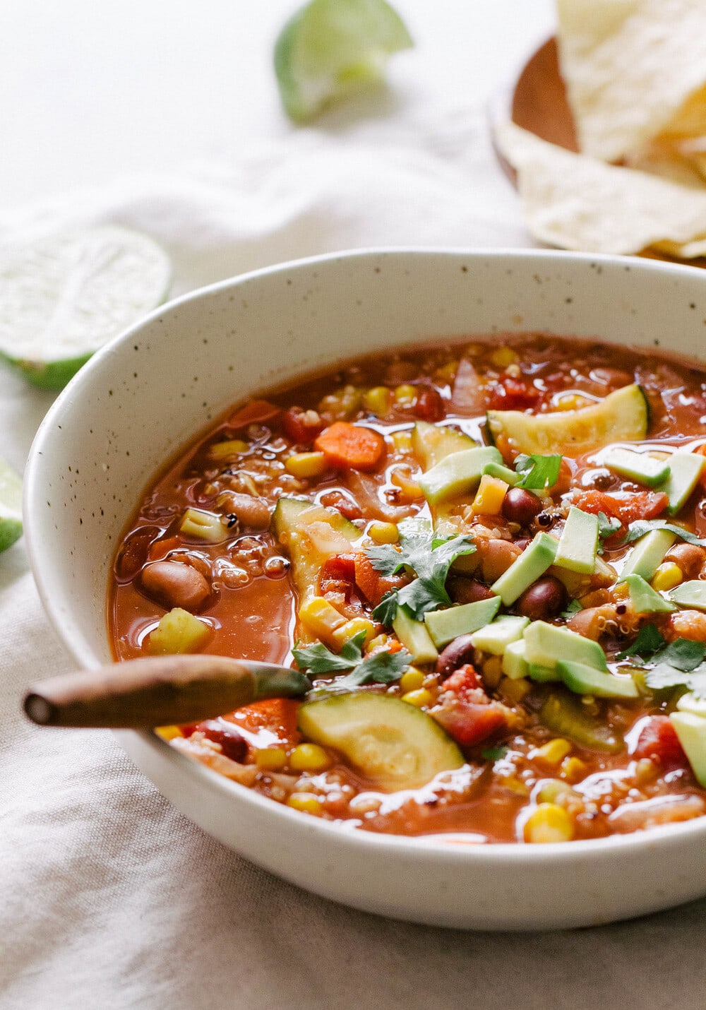 side angle view of a bowl with a serving of healthy tex mex quinoa vegetable soup.