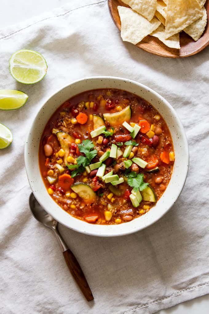 top down view of a bowl with a serving of tex mex quinoa vegetable soup.