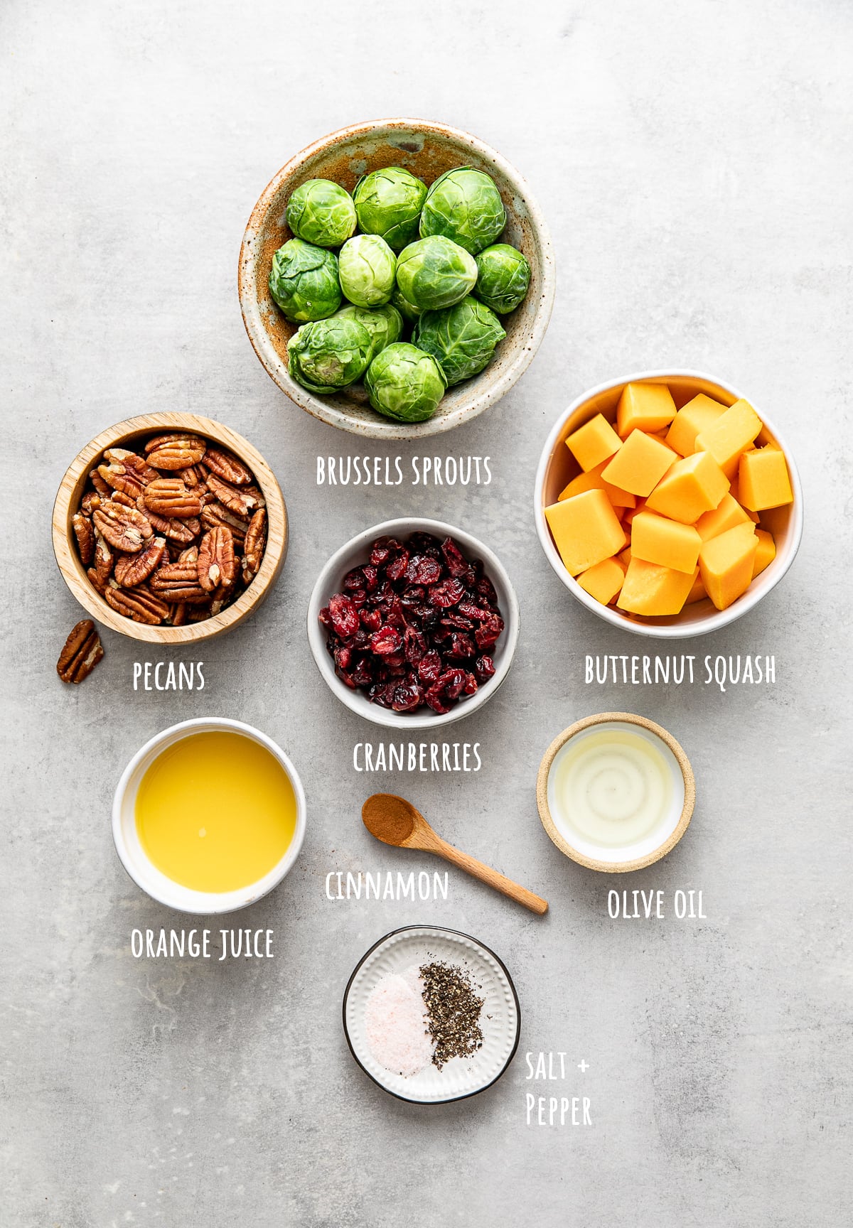 top down view of ingredients used to make vegan roasted brussles sprouts and butternut squash with cranberries and pecans.