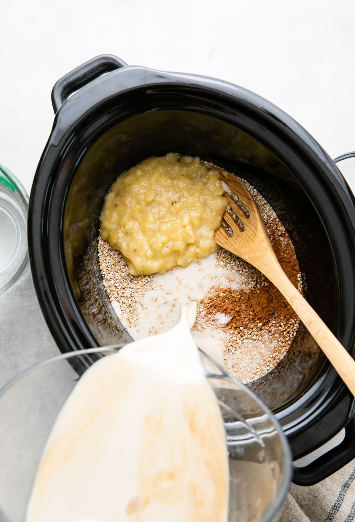 top down view showing the process of making overnight steel cut oats in a slow cooker.