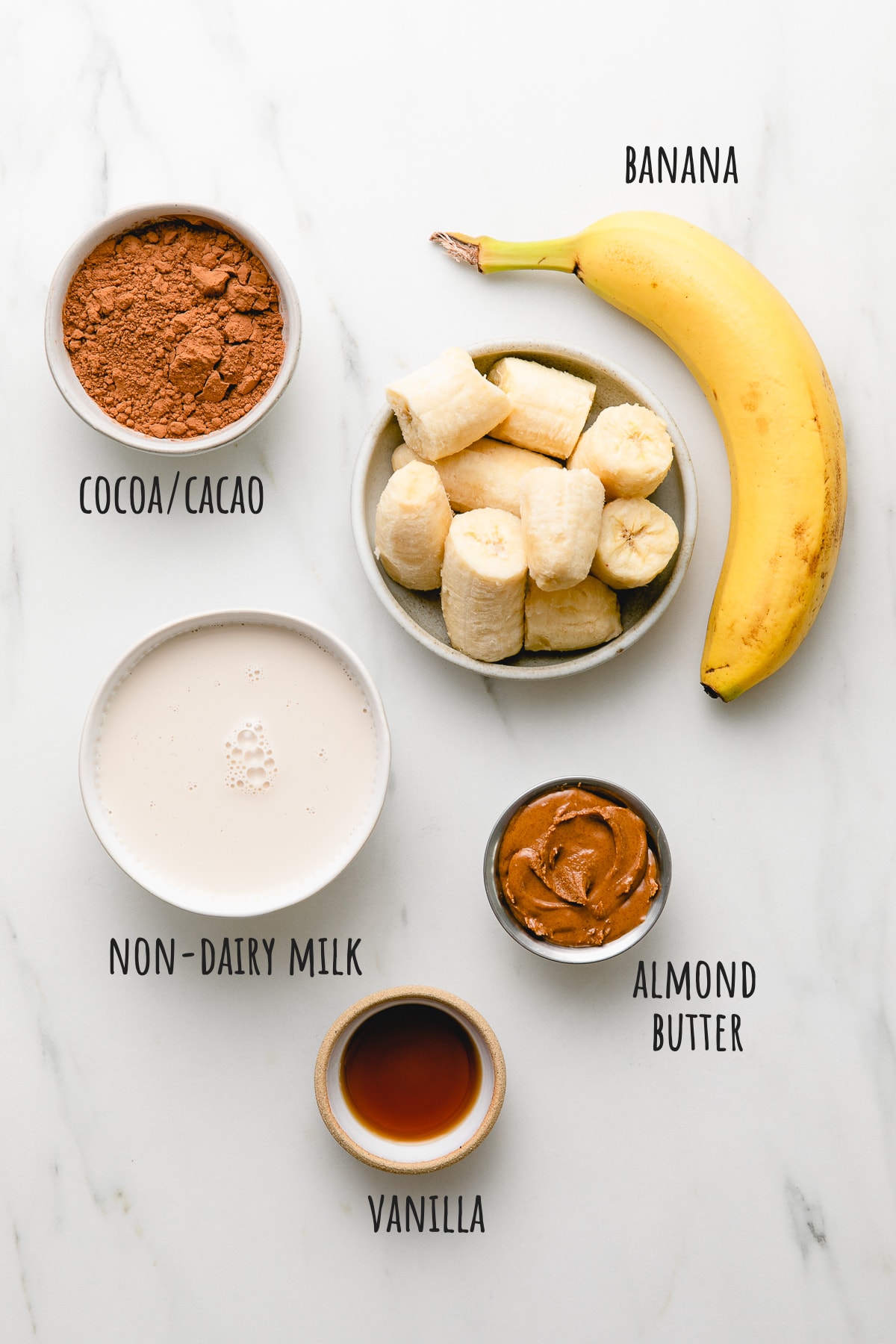 top down view of ingredients used to make chocolate almond butter smoothie bowl.