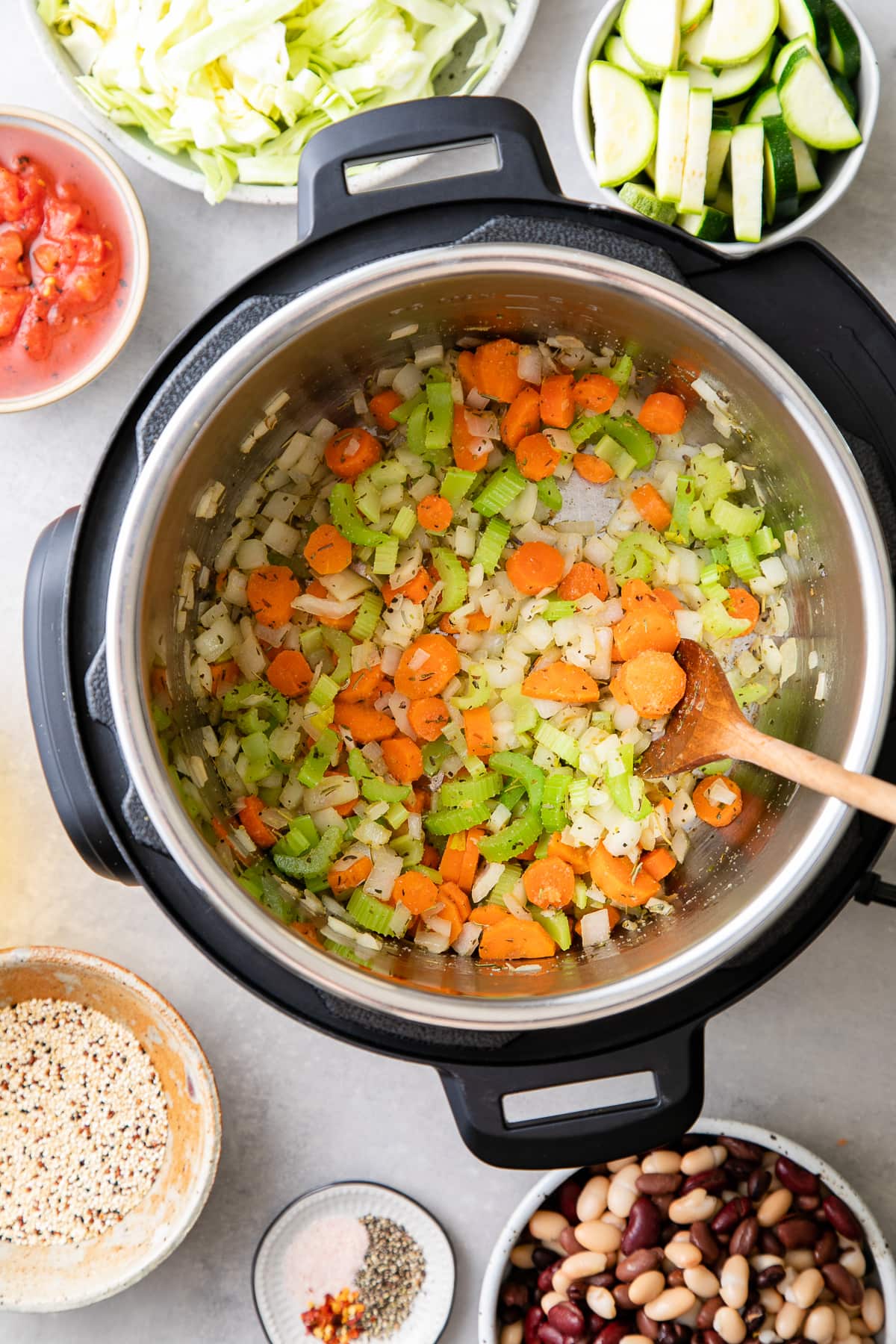 top down view of sauteed carrots, onion and celery in Instant Pot.