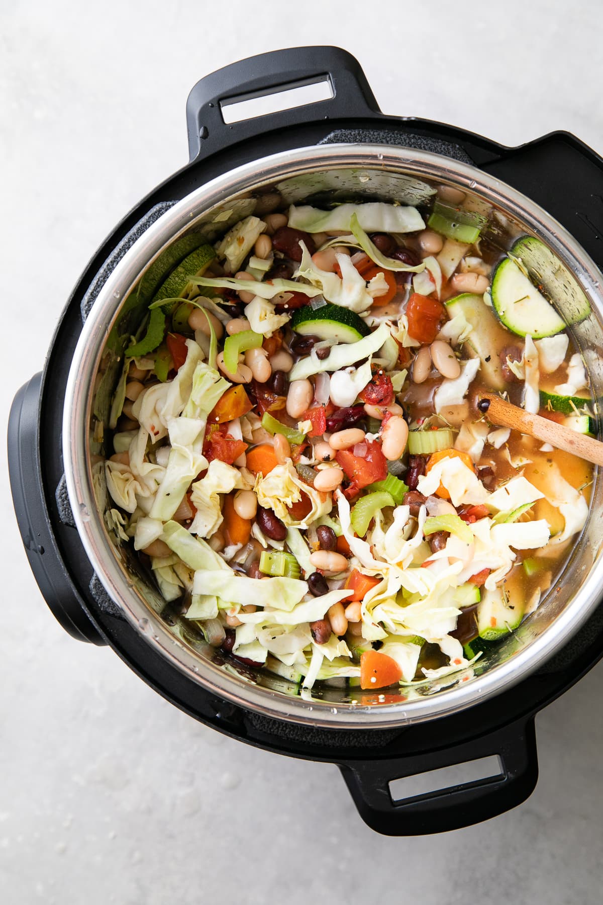 top down view of soup ingredients stirred and ready to cook.