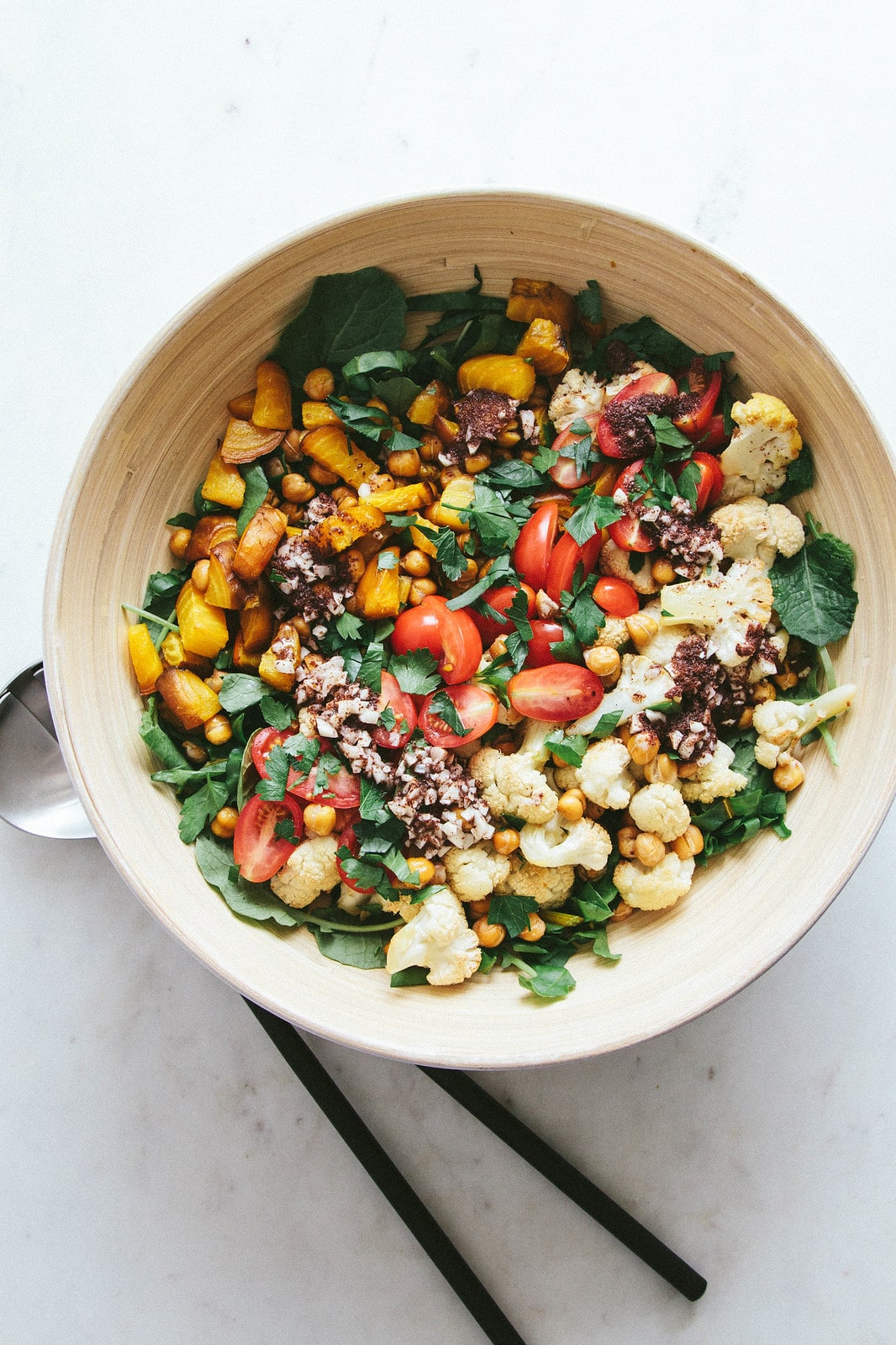 top down view of salad ingredients added to bowl before mixing.