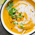 top down view of bowl of curry sweet potato and red lentil soup.