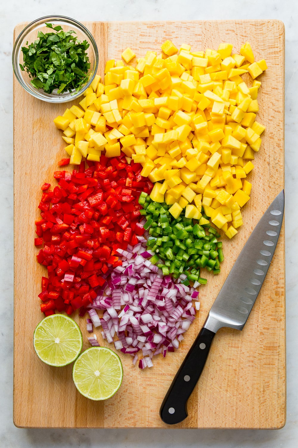 top down view of prepped ingredients needed to make mango salsa.