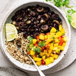 top down view of bowl with serving of healthy cuban black bean mango bowl with quinoa.