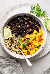 top down view of bowl with serving of healthy cuban black bean mango bowl with quinoa.