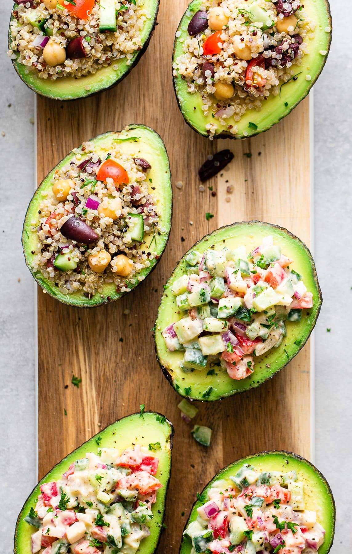 top down view of stuffed avocados on serving board.