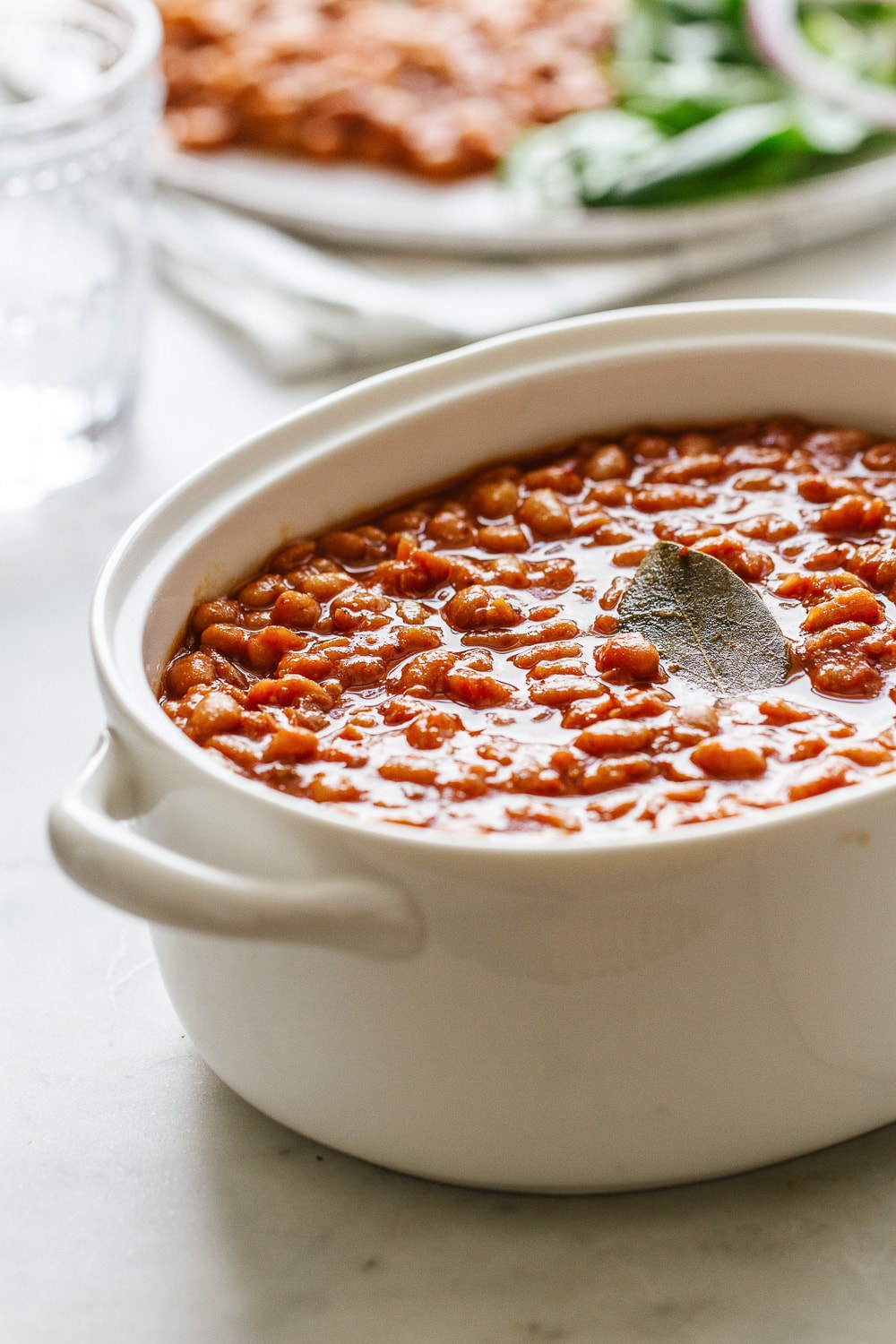 side angle view of healthy baked beans in a serving dish.