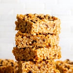 head on shot of peanut butter cacao nibs rice crispy treats cut into pieces and stacked