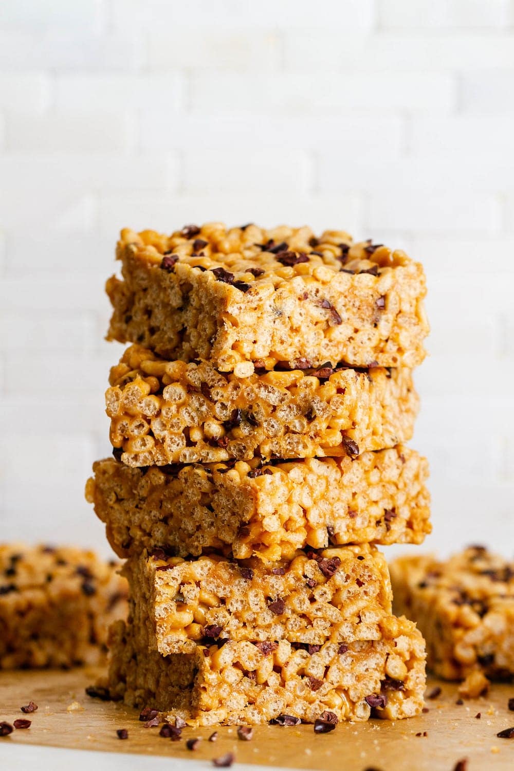head on shot of peanut butter cacao nibs rice crispy treats cut into pieces and stacked