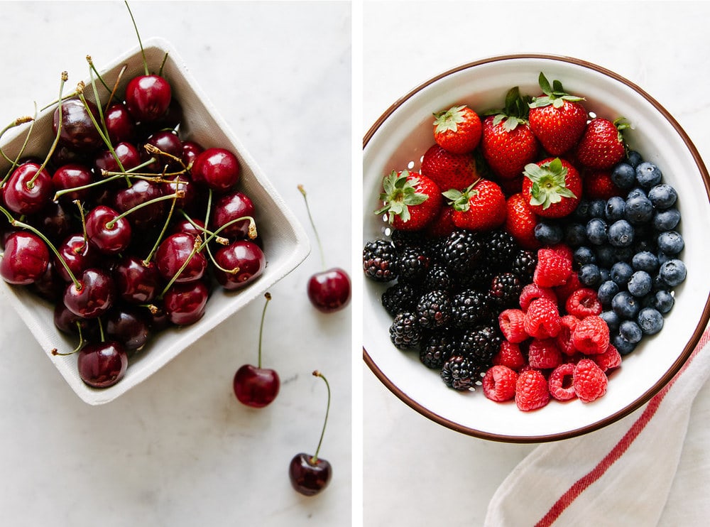 side by side shot of bowl with cherries and colander with mixed berries