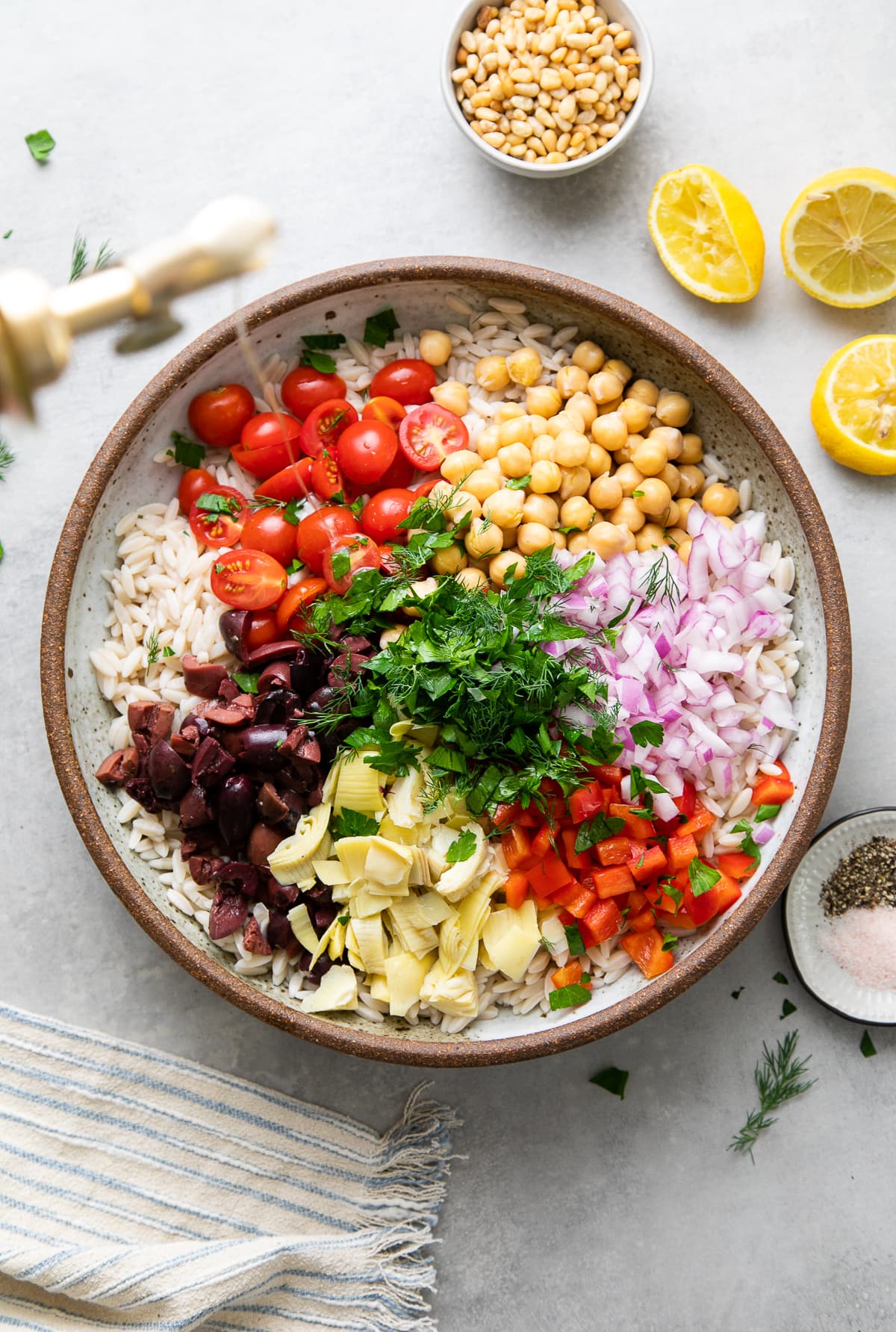 top down view showing the process of making best Mediterranean orzo salad.