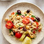 a serving of mediterranean orzo salad on a small plate