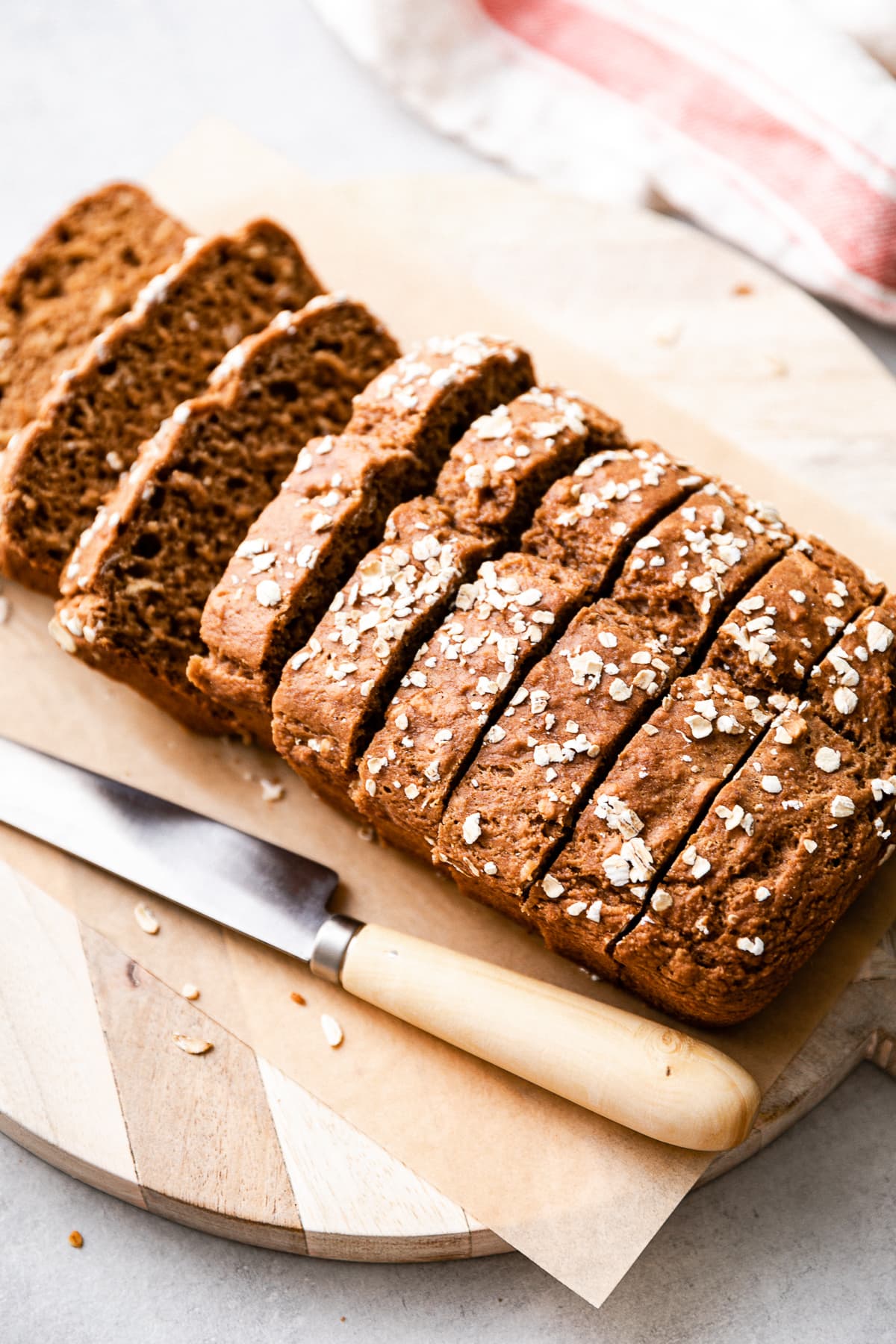 side angle view of healthy applesauce bread sliced on a serving board.