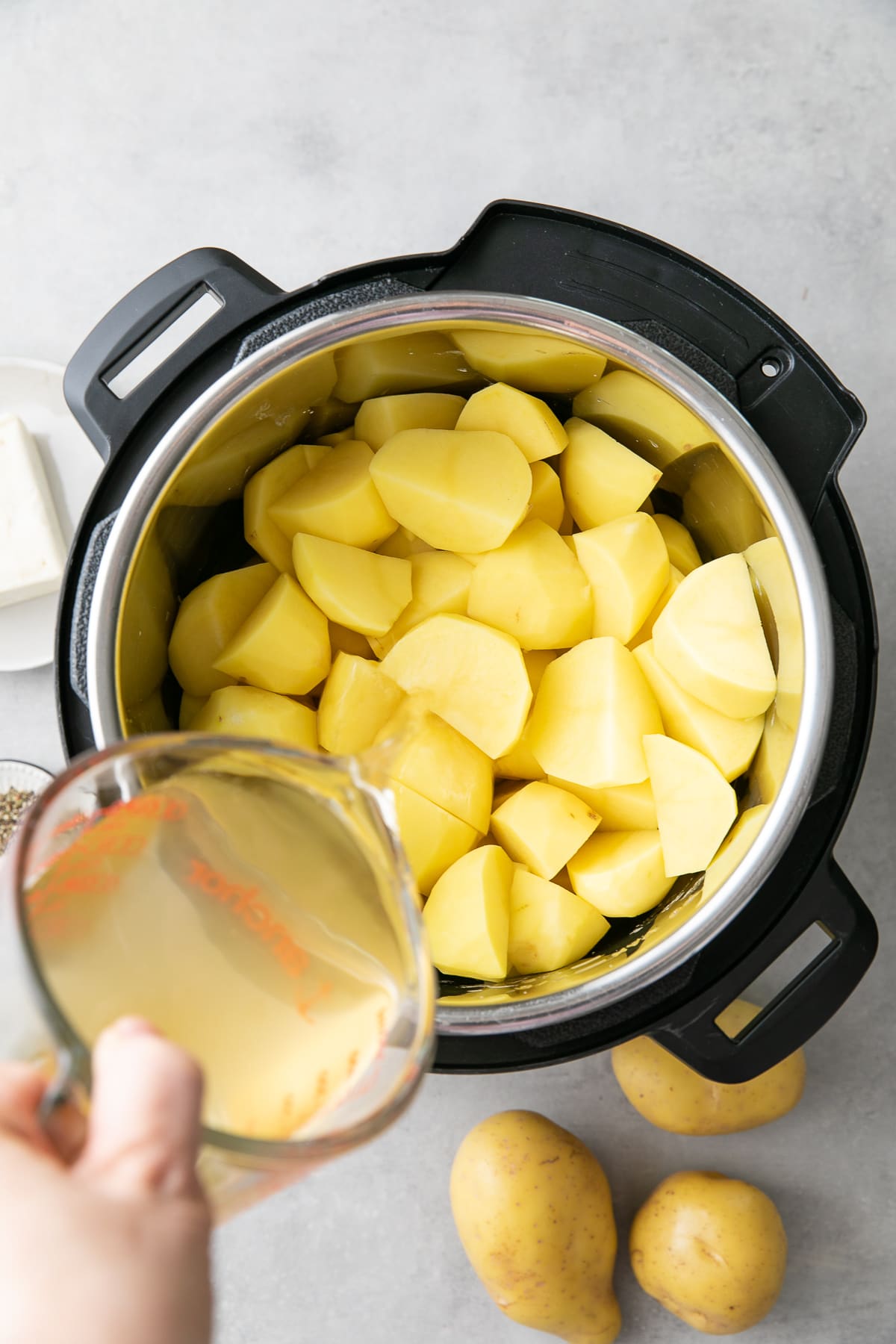 top down view showing the process of making Instant Pot mashed potatoes.