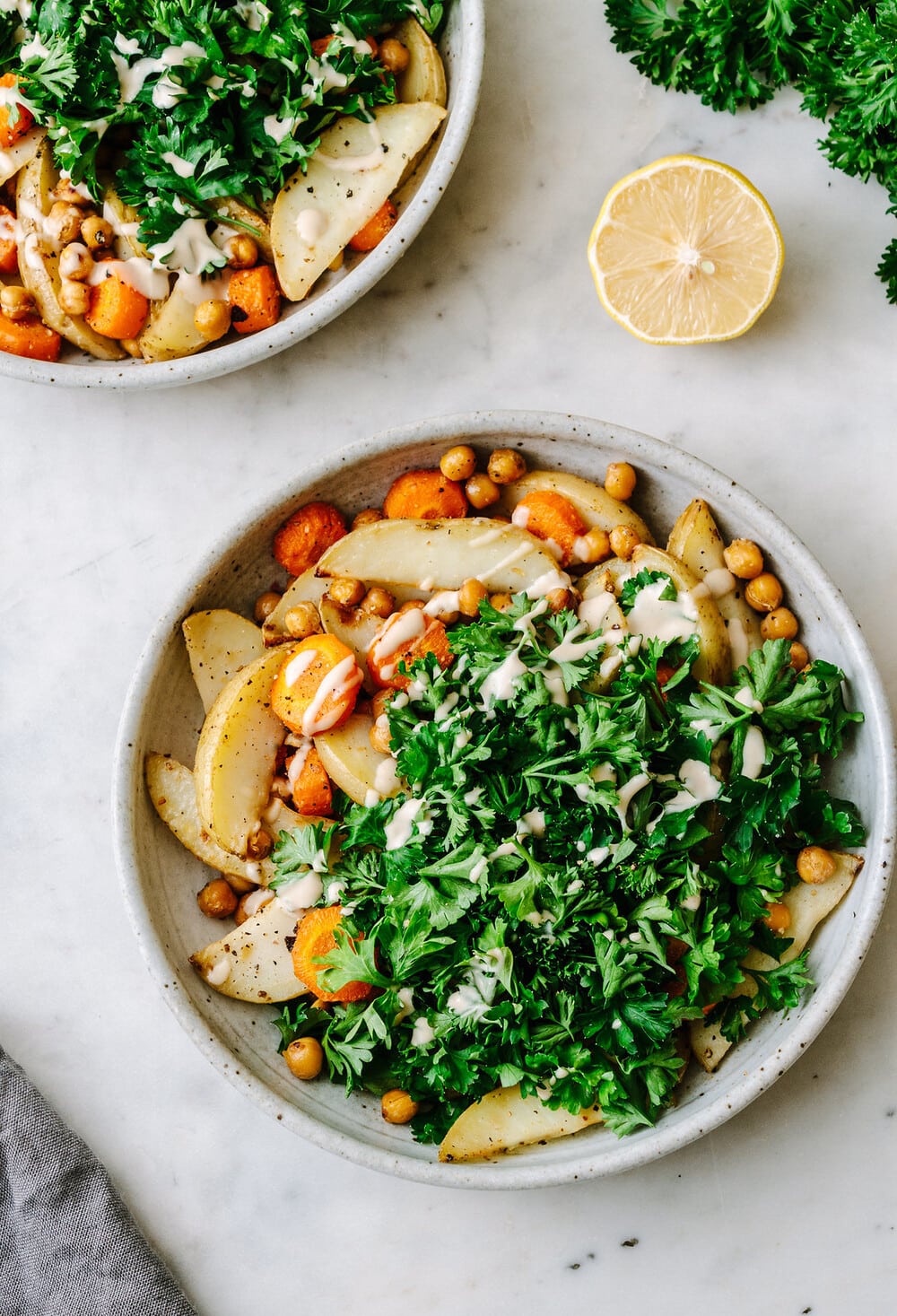 top down view of bowl of roasted chickpea, potato and parsley bowl.