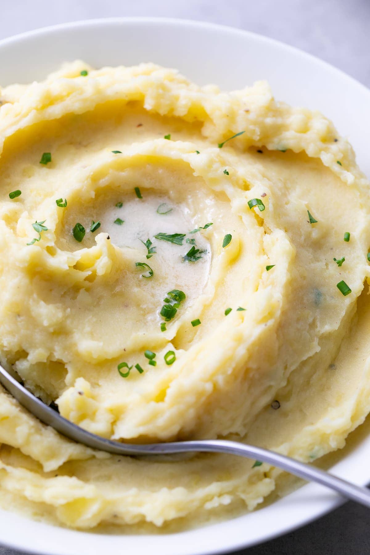 side angle view of serving bowl filled with the best Instant Pot mashed potatoes.