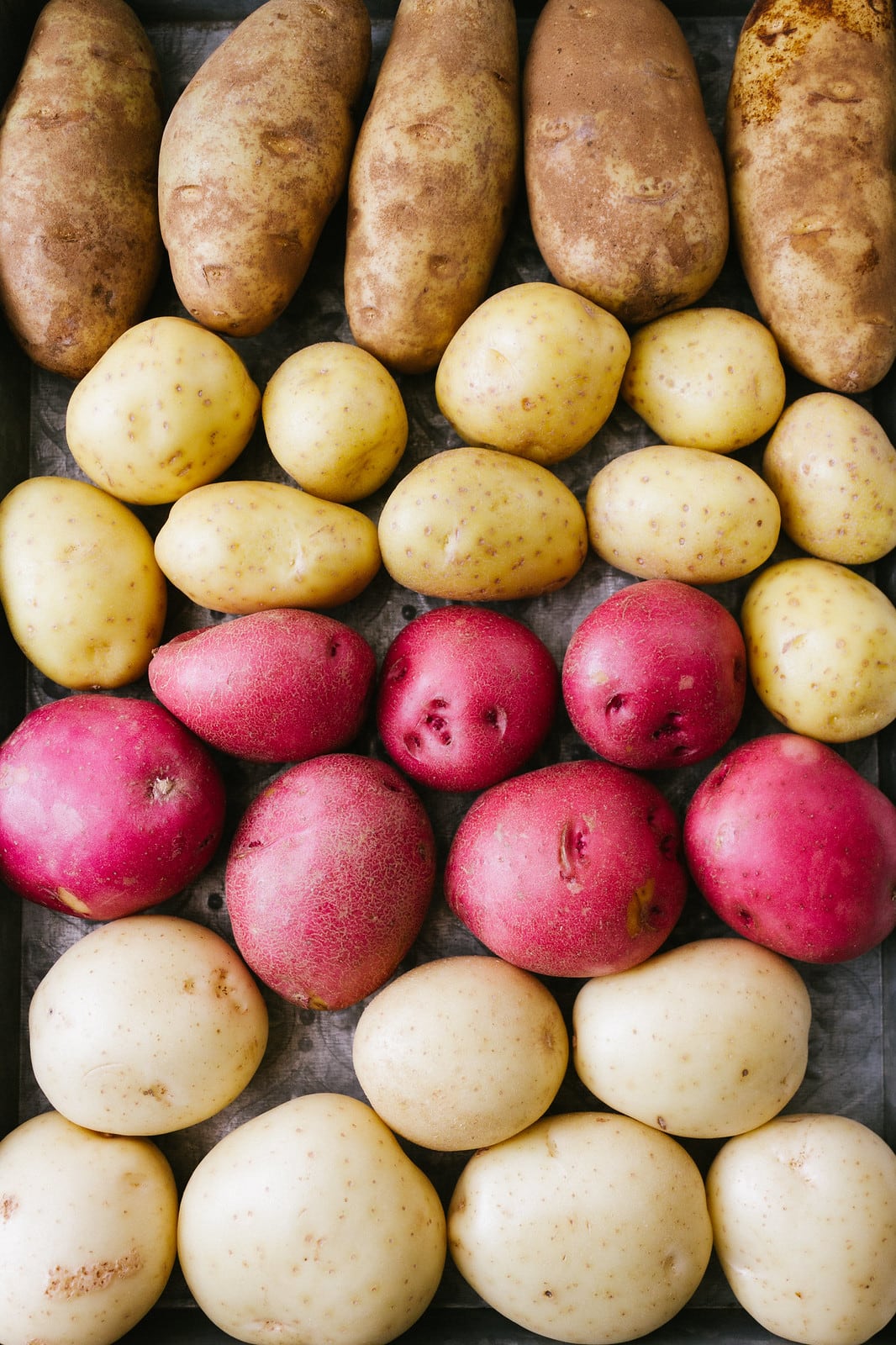 top down view of different types of potatoes for making vegan mashed potatoes.